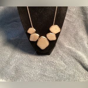 Large iridescent ivory colored stone necklace.